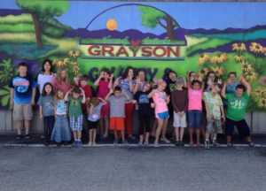 A group of kids plays outside grayson gallery and art center in carter county, kentucky.