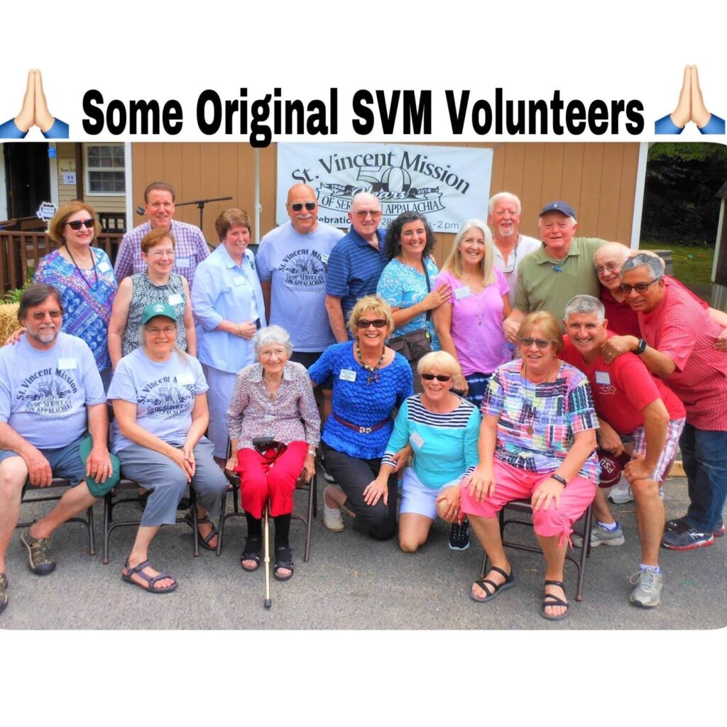 a group of people sit together who were some of the original volunteers at saint vincent mission