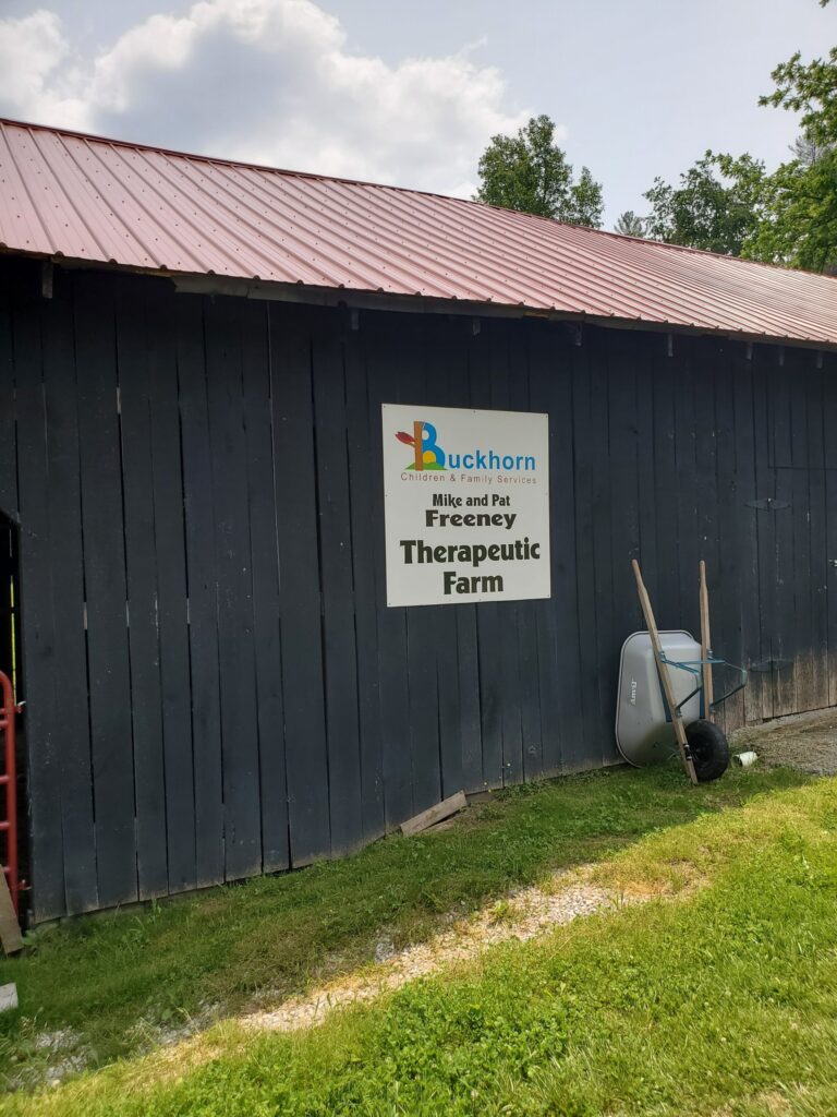 a sign reads therapeutic farm at buckhorn in eastern kentucky