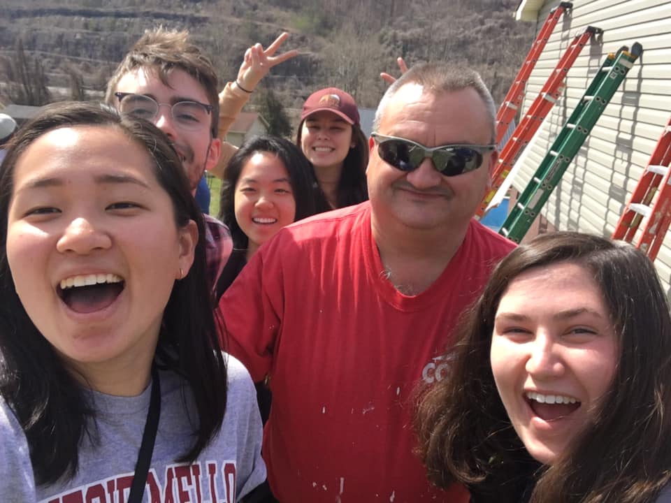 Volunteers stand with COAP, Inc. employee. COAP is a housing non-profit in Southeastern Kentucky.