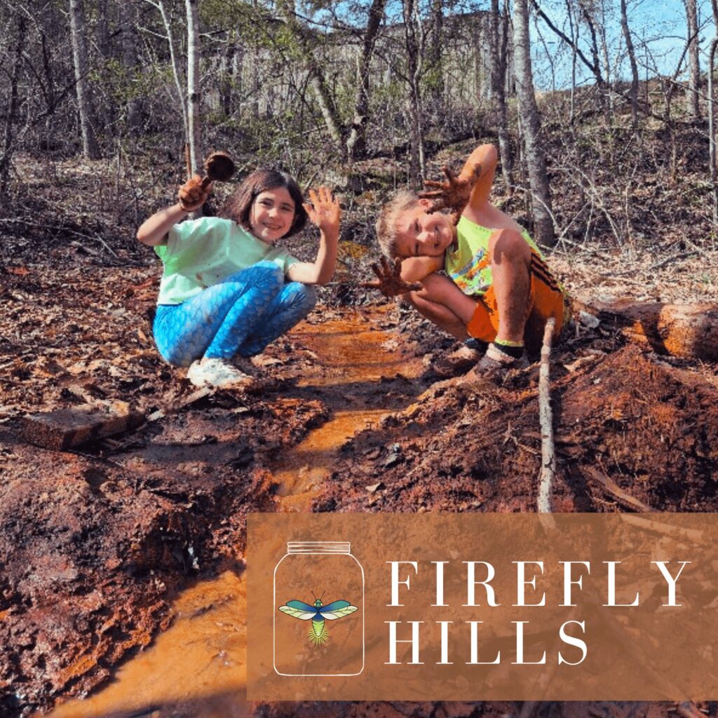 Two kids play in the mud kitchen at Firefly Hills RV Park