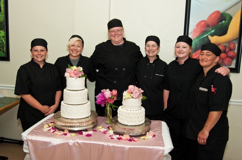 Students of Fruits of Labor stand with decorated cakes in Rainelle, West Virginia. Students are risk youth and women in recovery. They receive training in culinary arts and agriculture.