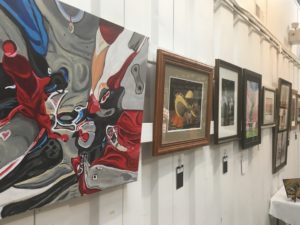 Pictures hang on a wall at grayson art gallery in eastern kentucky.