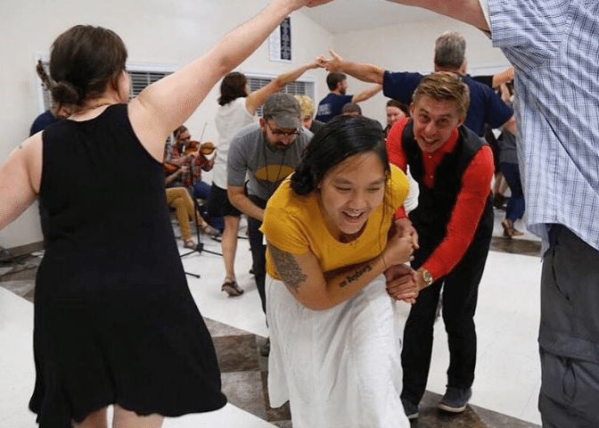 A group participates in a square dance in Appalachian kentucky. Events help counter the stigma around addiction recovery.