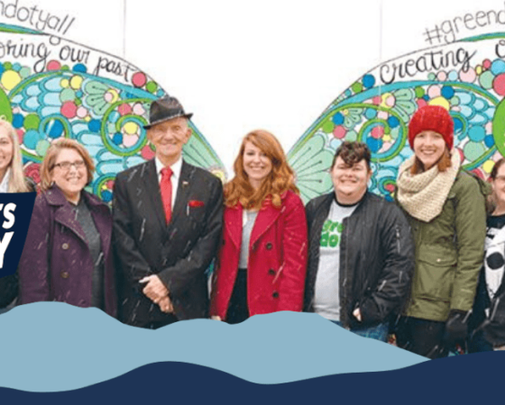 Williamsburg Kentucky poses with Green Dot Mural