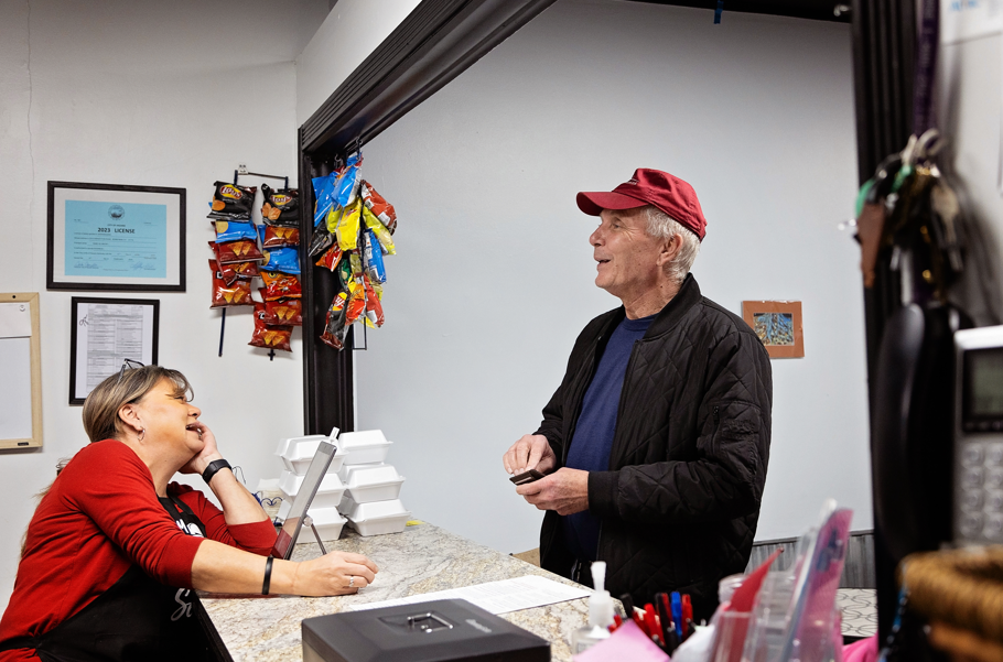 michelle laughs with a customer at shenanigans in hazard kentucky